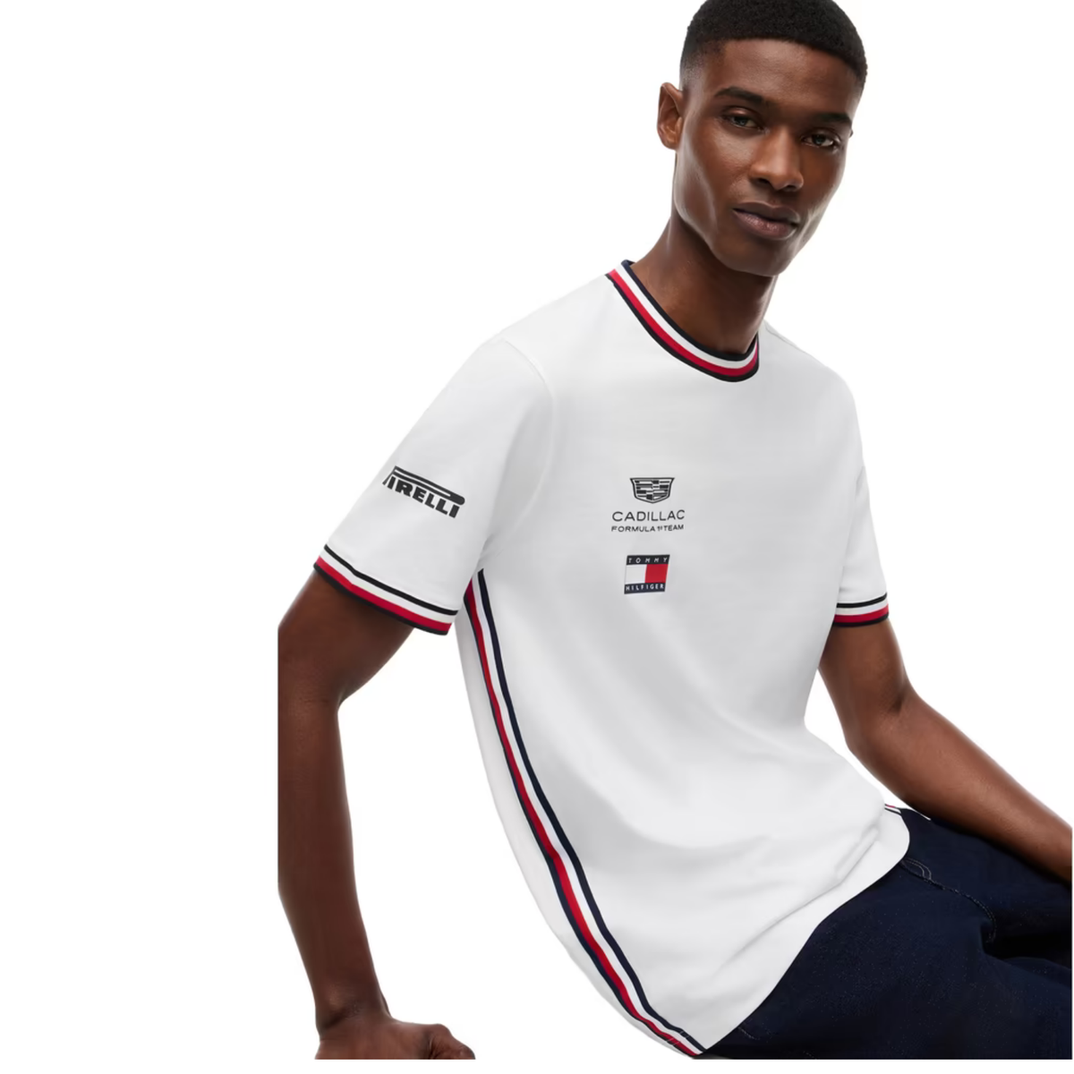 A white Tommy Hilfiger Formula 1 Team t-shirt featuring a ribbed crew neck and sleeve cuffs with red and navy stripes, and official sponsor logos including Cadillac and Pirelli across the chest and sleeves.