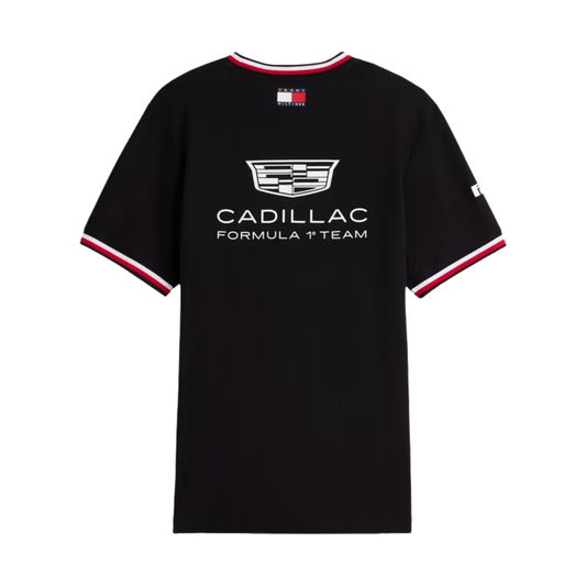 A black Tommy Hilfiger Cadillac Formula 1 Team t-shirt featuring a crew neck and sleeve cuffs with red and white stripes, and official sponsor logos including Cadillac and Pirelli across the chest and sleeves.