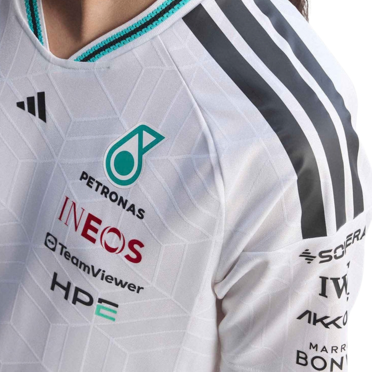 A white Mercedes-AMG Petronas 2026 team t-shirt featuring a V-neck collar with black shoulder stripes and vibrant teal inner trim, and official partner logos including Mercedes-AMG, Petronas, and UBS across the chest.
