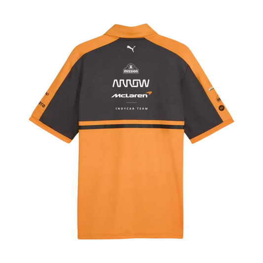 A papaya orange and charcoal Arrow McLaren IndyCar Team t-shirt featuring a crew neck, orange shoulder panels, and official partner logos including Chevrolet and Arrow McLaren IndyCar Team across the chest.