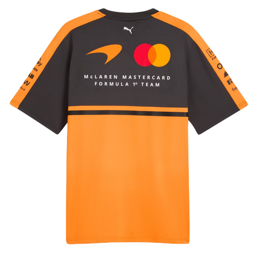 A papaya orange and charcoal McLaren F1 2026 team t-shirt featuring a crew neck and official partner logos including Android, Dell Technologies, OKX, and Optimum Nutrition across the chest.