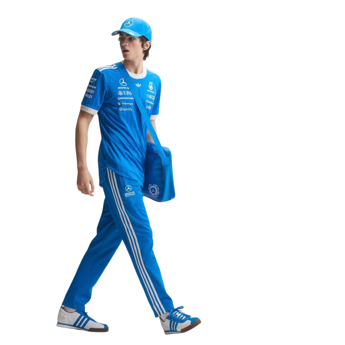 A blue and white Mercedes-AMG Petronas 2026 blue edition t-shirt featuring an all-over vertical pinstripe pattern, a white crew neck and sleeve cuffs, and official partner logos including Mercedes-AMG, Petronas, and UBS across the chest.