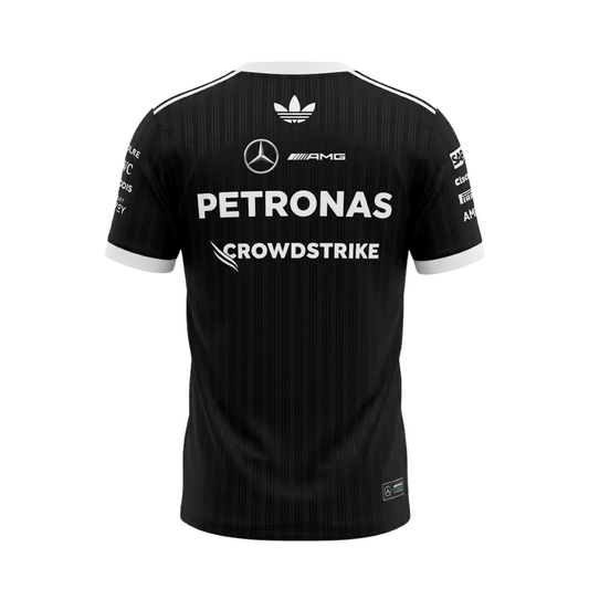 A black and white Mercedes-AMG Petronas 2026 black edition t-shirt featuring an all-over vertical pinstripe pattern, a white crew neck and sleeve cuffs with white shoulder stripes, and official partner logos including Mercedes-AMG, Petronas, and UBS across the chest.