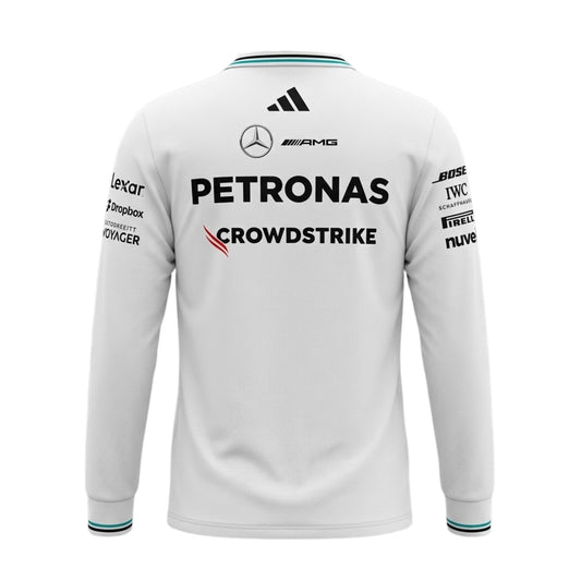 A white Mercedes-AMG Petronas 2026 team long-sleeve t-shirt featuring a V-neck collar with black shoulder stripes and teal inner trim, ribbed cuffs with contrast striping, and official partner logos including Mercedes-AMG, Petronas, and UBS across the chest.