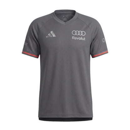 Official Audi 2026 team T-shirt in dark grey, featuring sponsor logos including Revolut, adidas, and Pirelli.