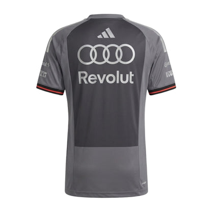 Official Audi 2026 team T-shirt in dark grey, featuring sponsor logos including Revolut, adidas, and Pirelli.