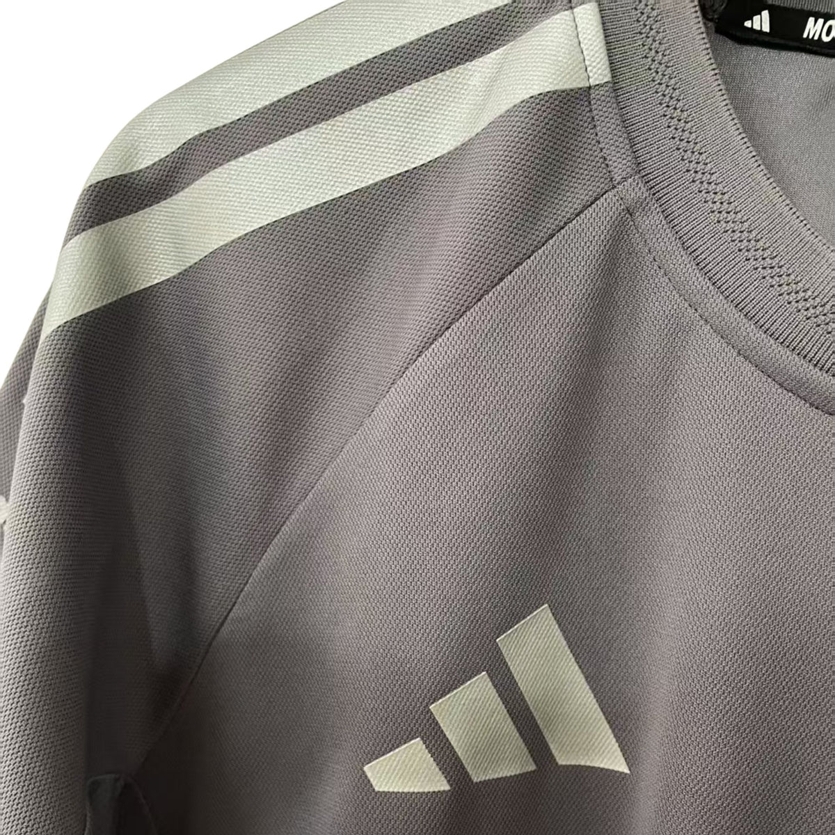 Official Audi 2026 team T-shirt in dark grey, featuring sponsor logos including Revolut, adidas, and Pirelli.