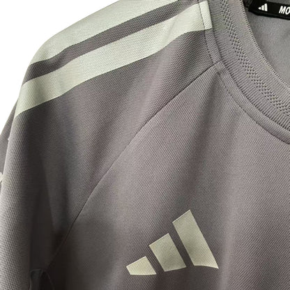 Official Audi 2026 team T-shirt in dark grey, featuring sponsor logos including Revolut, adidas, and Pirelli.