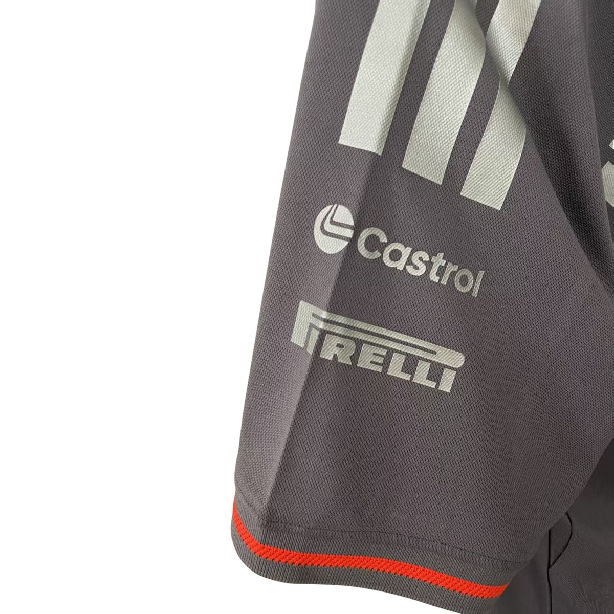 Official Audi 2026 team T-shirt in dark grey, featuring sponsor logos including Revolut, adidas, and Pirelli.