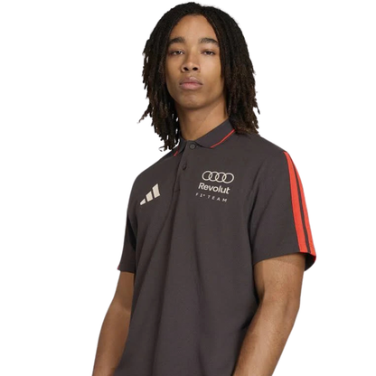 Official Audi 2026 team polo shirt in dark grey, featuring sponsor logos including Revolut, adidas, and Castrol.