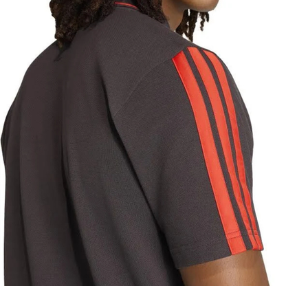 Official Audi 2026 team polo shirt in dark grey, featuring sponsor logos including Revolut, adidas, and Castrol.