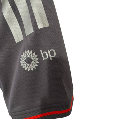 Official Audi 2026 team polo shirt in dark grey, featuring sponsor logos including Revolut, adidas, and Castrol.