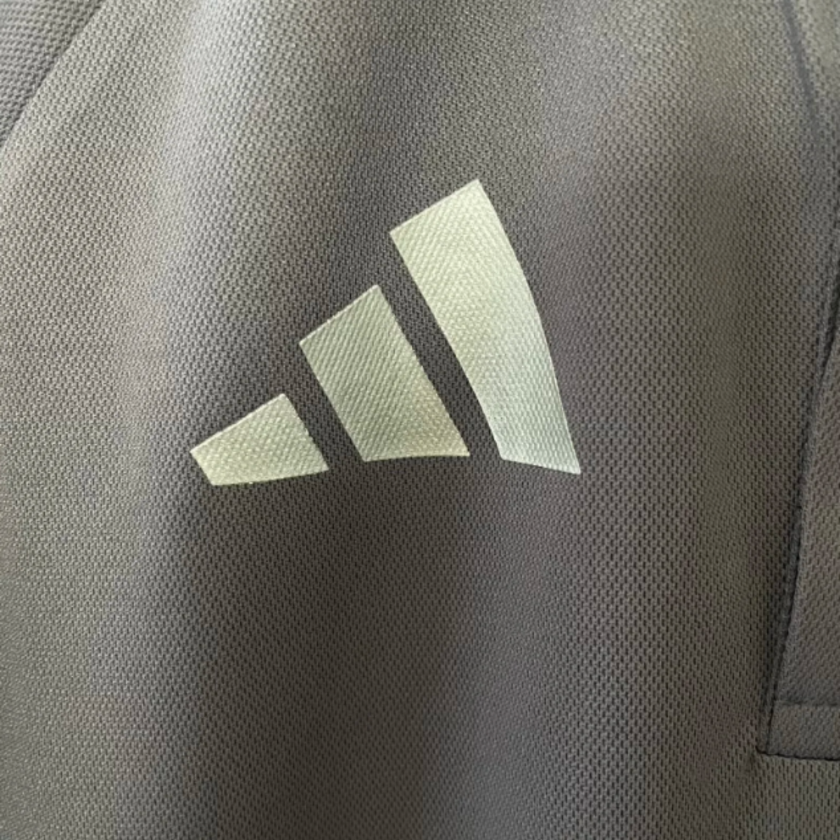 Official Audi 2026 team polo shirt in dark grey, featuring sponsor logos including Revolut, adidas, and Castrol.