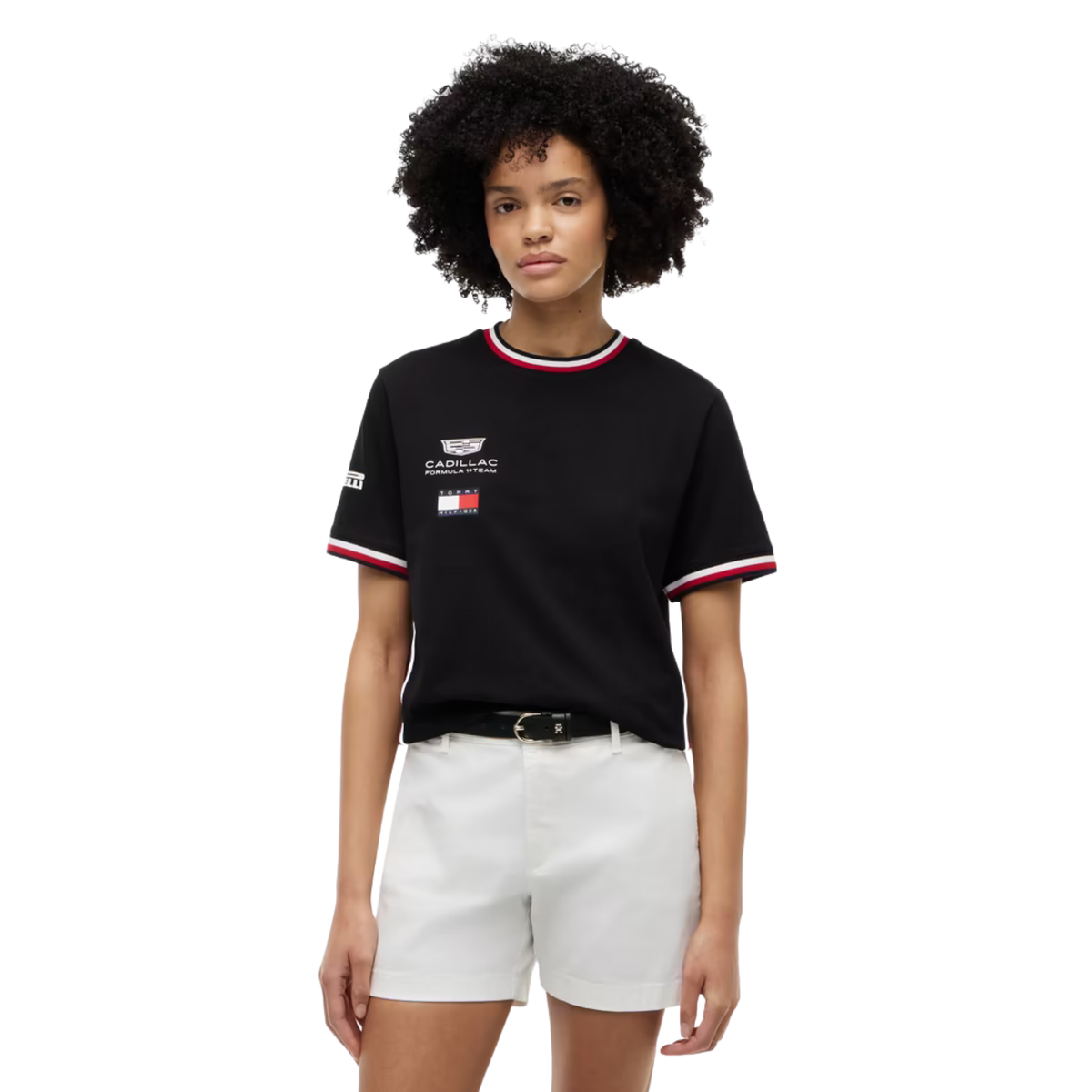 A black Tommy Hilfiger Cadillac Formula 1 Team t-shirt featuring a crew neck and sleeve cuffs with red and white stripes, and official sponsor logos including Cadillac and Pirelli across the chest and sleeves.