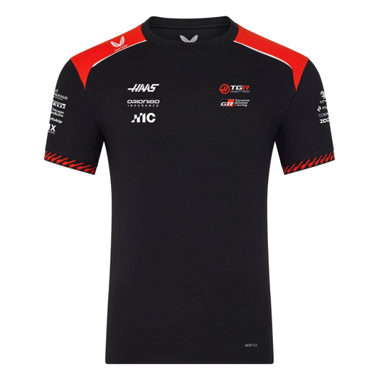 A black and red MoneyGram Haas F1 Team 2026 team t-shirt featuring a crew neck, red shoulder accents, and official partner logos including Haas, Toyota Gazoo Racing, and Orion180 across the chest.