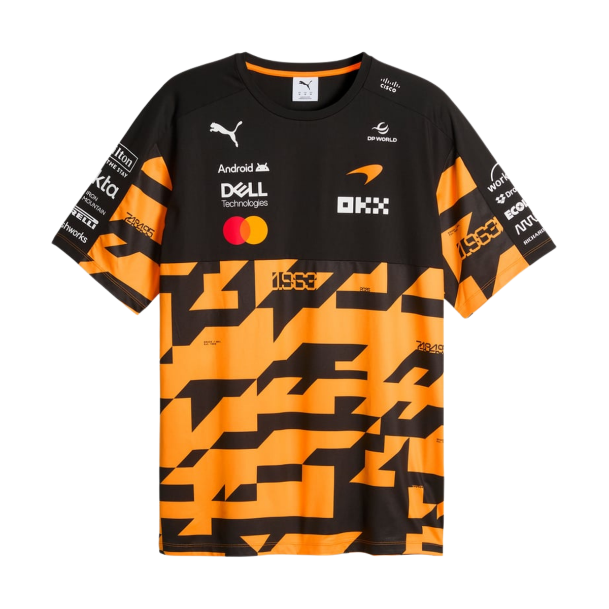 A black, orange, and charcoal McLaren F1 special edition 1000th race t-shirt featuring a crew neck, a bold geometric graphic pattern across the lower half, and official partner logos including Android, Dell Technologies, OKX, and DP World on the chest.