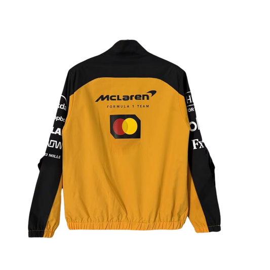 A papaya orange and black McLaren F1 2026 team windbreaker jacket featuring a full front zipper, stand-up collar, and sponsor logos including Android, Dell Technologies, and OKX across the chest.