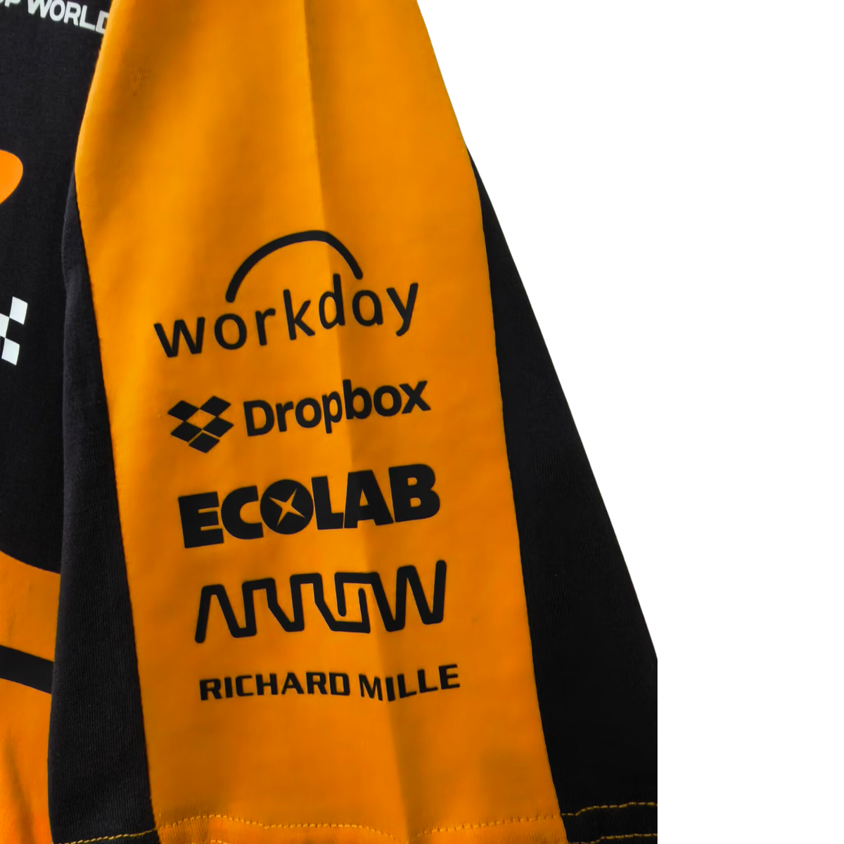 A papaya orange and charcoal McLaren F1 2026 team t-shirt featuring a crew neck and official partner logos including Android, Dell Technologies, OKX, and Optimum Nutrition across the chest.