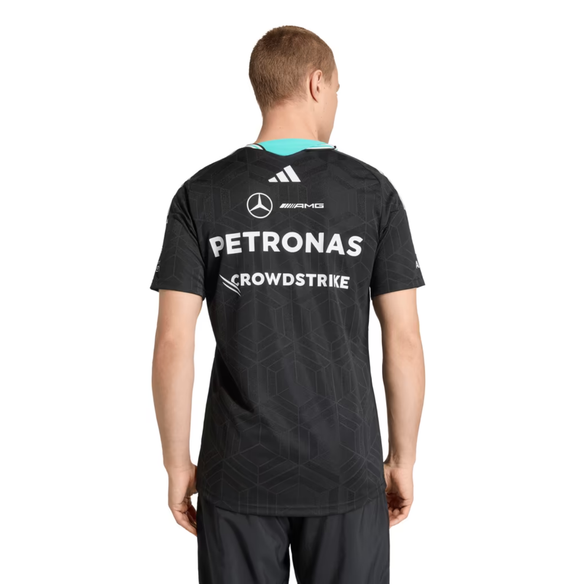 A black Mercedes-AMG Petronas 2026 driver t-shirt featuring an all-over tonal geometric pattern, a V-neck collar with white shoulder stripes and vibrant teal inner trim, and official partner logos including Mercedes-AMG, Petronas, and UBS across the chest.