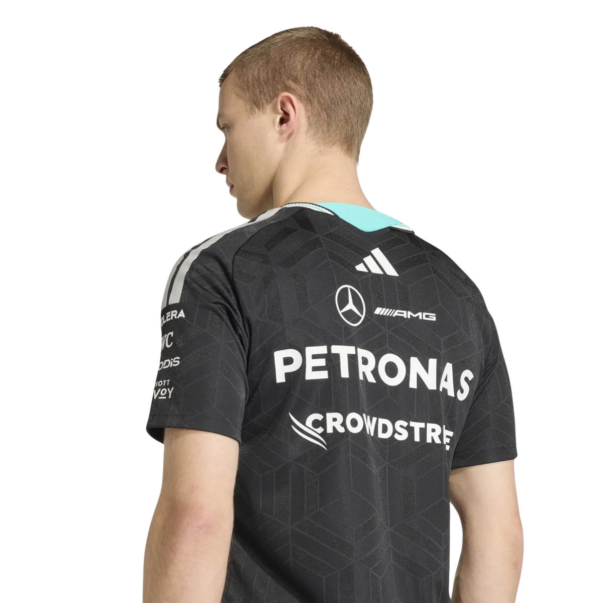 A black Mercedes-AMG Petronas 2026 driver t-shirt featuring an all-over tonal geometric pattern, a V-neck collar with white shoulder stripes and vibrant teal inner trim, and official partner logos including Mercedes-AMG, Petronas, and UBS across the chest.