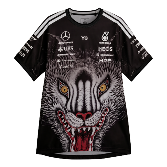 A special edition black Mercedes-AMG Petronas 2026 team t-shirt featuring a large graphic of a howling wolf's face on the front, white shoulder stripes, and official partner logos including Mercedes-AMG, Petronas, and Y-3 across the chest.