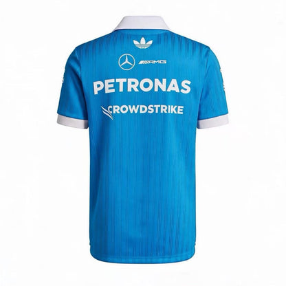 Official Mercedes-AMG Petronas 2026 team polo shirt in blue with a white collar, featuring sponsor logos including INEOS, UBS, and CrowdStrike.