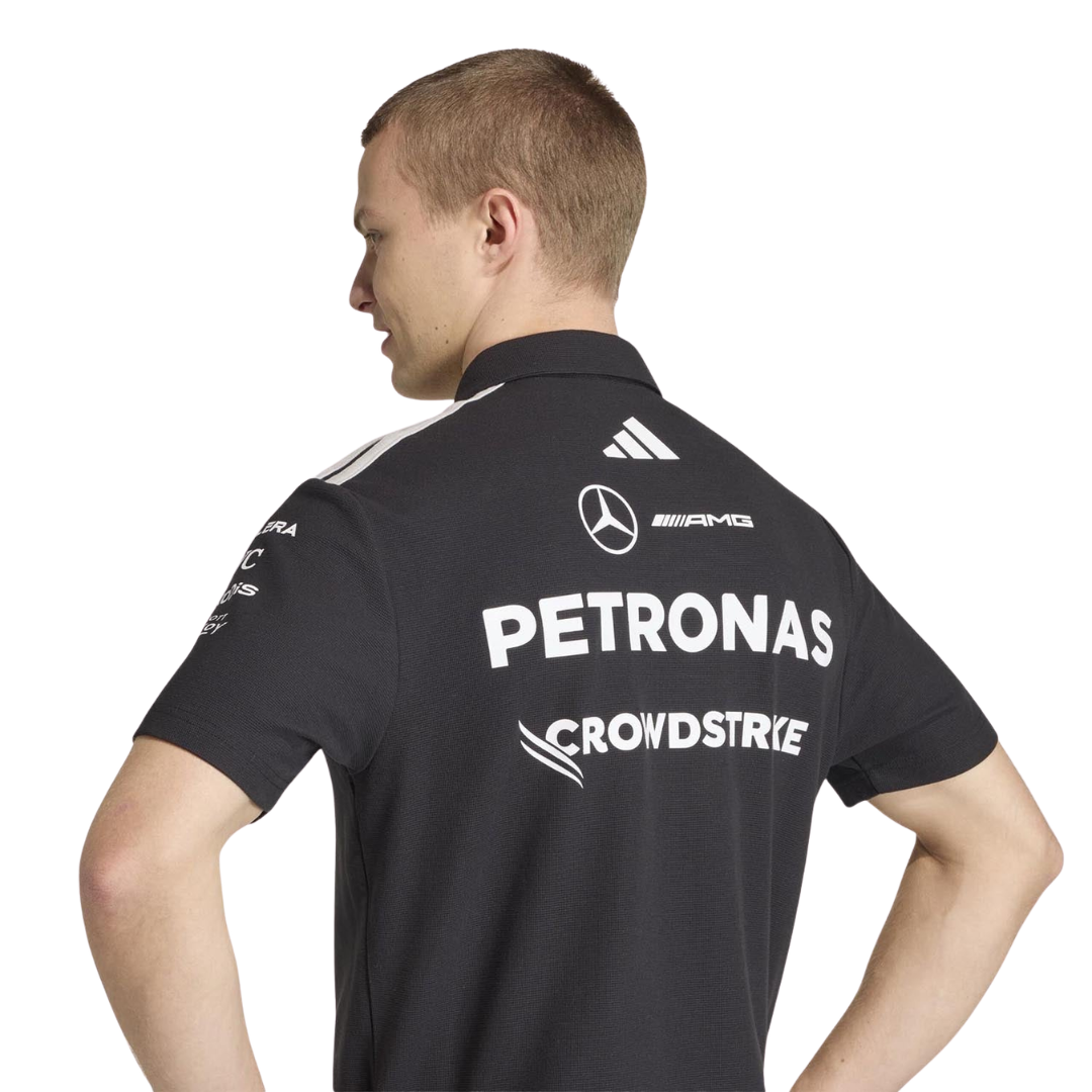 Official Mercedes-AMG Petronas 2026 team polo shirt in dark grey, featuring sponsor logos including INEOS, UBS, and CrowdStrike.