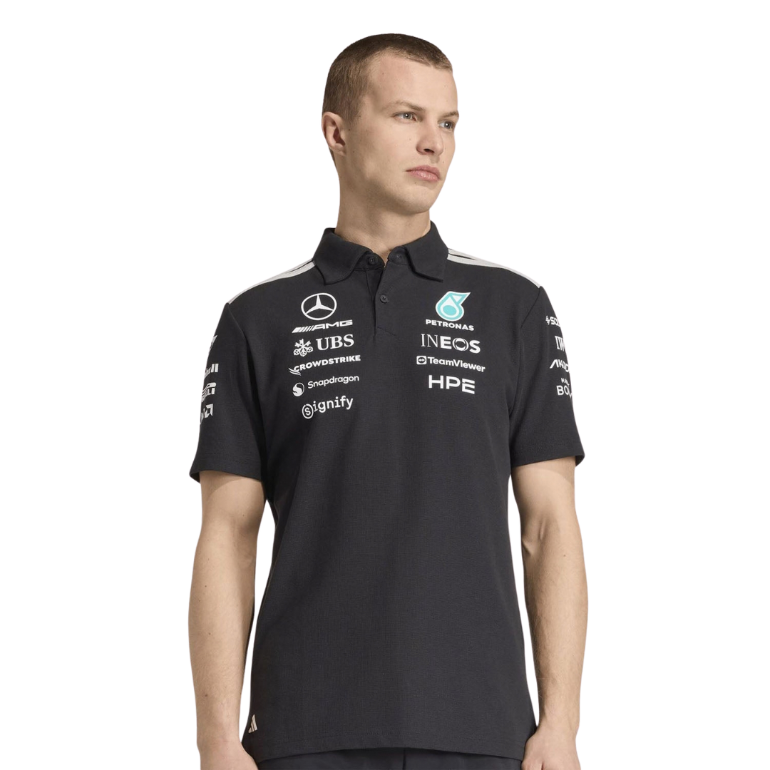 Official Mercedes-AMG Petronas 2026 team polo shirt in dark grey, featuring sponsor logos including INEOS, UBS, and CrowdStrike.