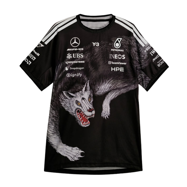 A special edition black Mercedes-AMG Petronas 2026 team t-shirt featuring a dynamic full-body crouching wolf graphic spanning the lower front and side, white shoulder stripes, and official partner logos including Mercedes-AMG, Petronas, and Y-3 across the chest.