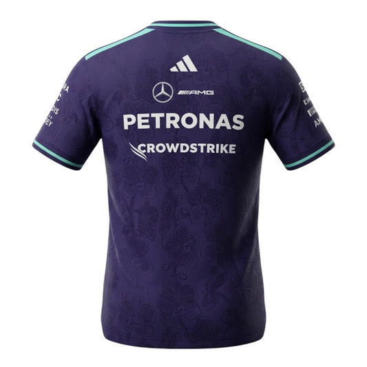 A special edition purple and teal Mercedes-AMG Petronas 2026 Singapore GP team t-shirt featuring an all-over tonal floral pattern, a crew neck with teal trim, and official partner logos including Mercedes-AMG, Petronas, and INEOS across the chest.