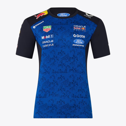 A navy blue and royal blue Oracle Red Bull Racing 2026 team t-shirt featuring a digital camouflage pattern, a crew neck, black sleeves, and prominent partner logos including TAG Heuer, Mobil 1, Ford Racing, and Oracle across the chest.
