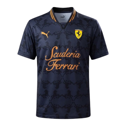 A dark gray and gold Scuderia Ferrari 2026 community t-shirt featuring a subtle all-over Prancing Horse pattern, a V-neck collar, and the classic "Scuderia Ferrari" script across the chest.