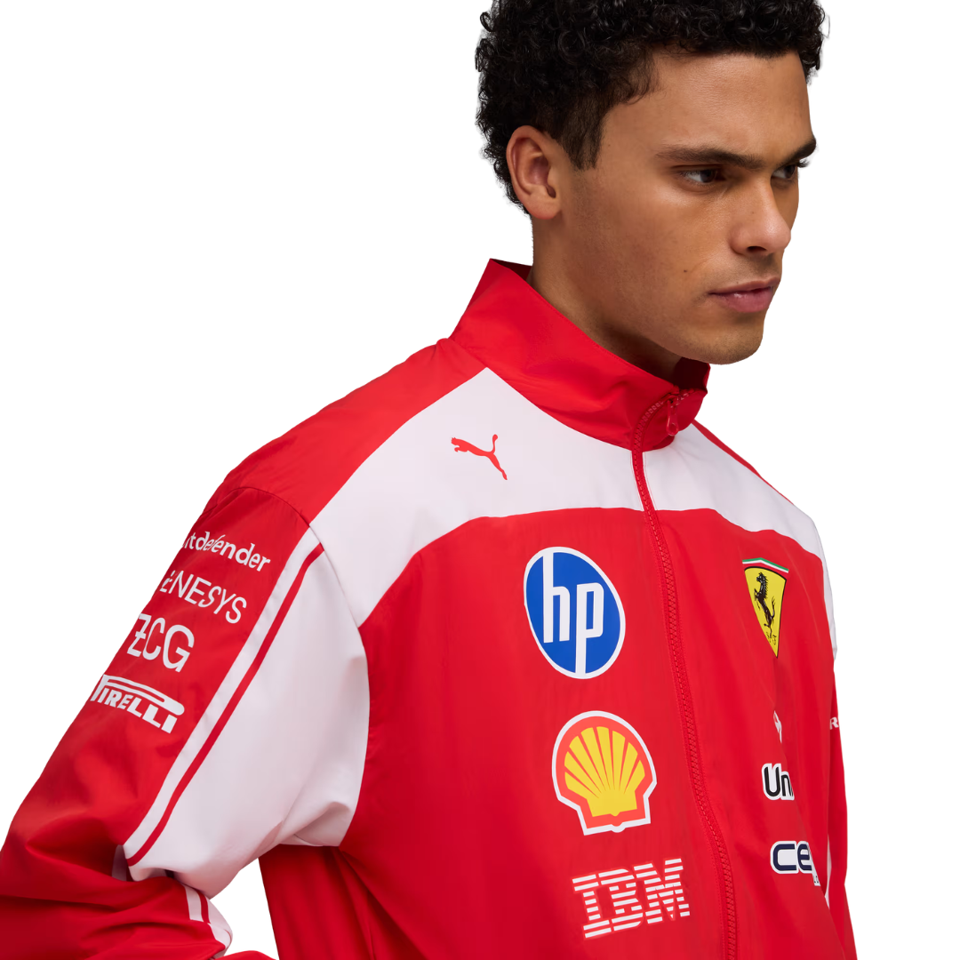 A red and white Scuderia Ferrari 2026 team windbreaker jacket and matching pants, featuring a full front zipper and sponsor logos including HP and Shell on the chest.