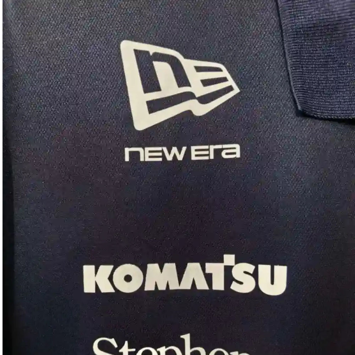 Official Williams Racing 2026 team polo shirt in navy blue, featuring sponsor logos including Gulf, Komatsu, and Duracell.
