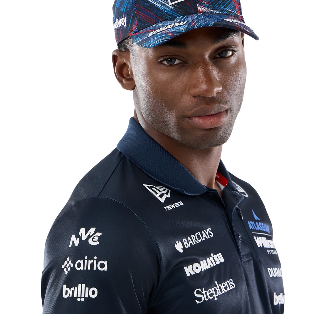 Official Williams Racing 2026 team polo shirt in navy blue and red, featuring sponsor logos including Gulf, Komatsu, and Duracell.